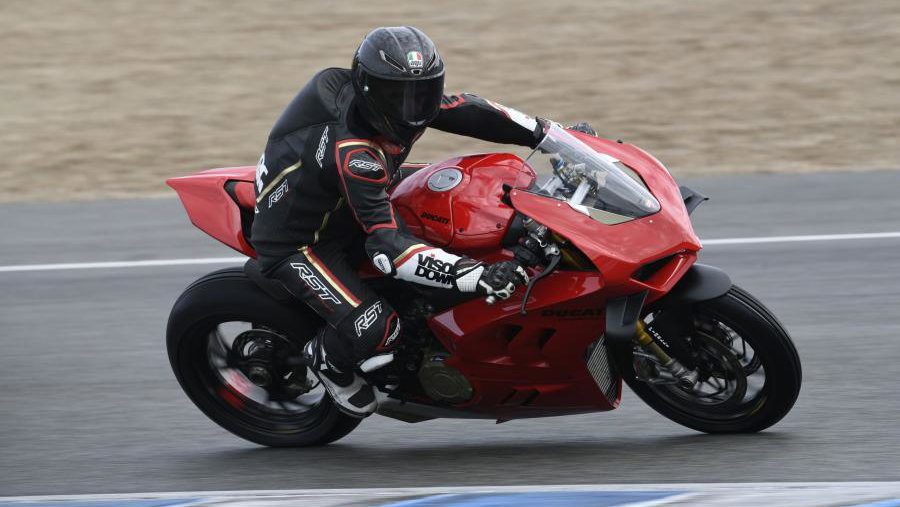 A red 2022 Ducati Panigale V4S being ridden around a racetrack